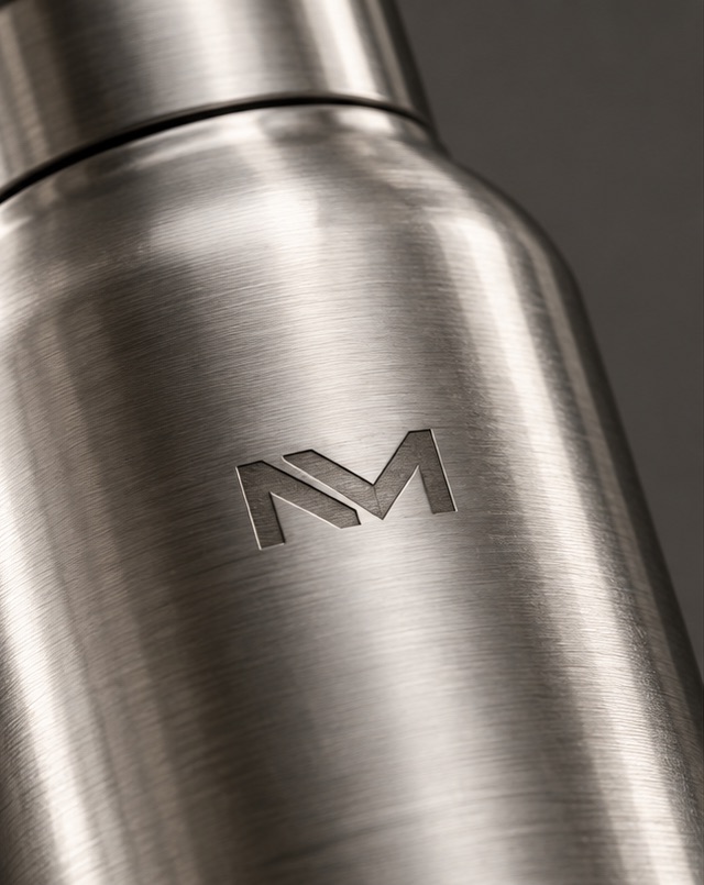 Monograma Niven Mark grabado con láser en el cuerpo de una botella de acero inoxidable cepillado.